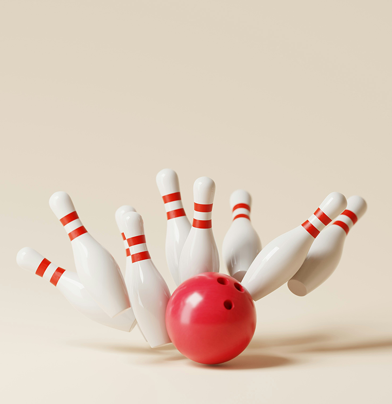 Red bowling ball striking pins.