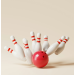 Red bowling ball striking pins.